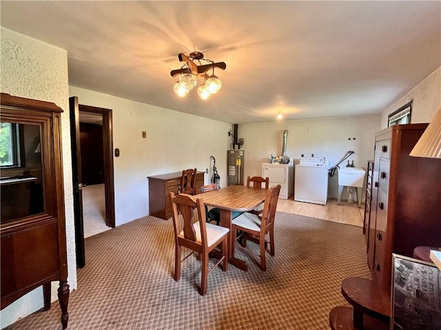 590 N Kings Creek Rd, Pa, PA 15021 - carpeted dining room featuring washer and dryer, water heater, a sink, a chandelier, and plenty of natural light