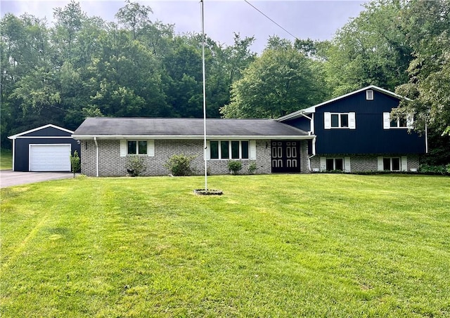 590 N Kings Creek Rd, Pa, PA 15021 - split level home featuring a detached garage, a front lawn, asphalt driveway, and brick siding