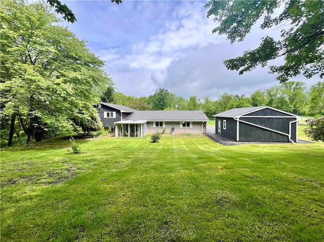 590 N Kings Creek Rd, Pa, PA 15021 - back of property with a lawn, brick siding, and a sunroom