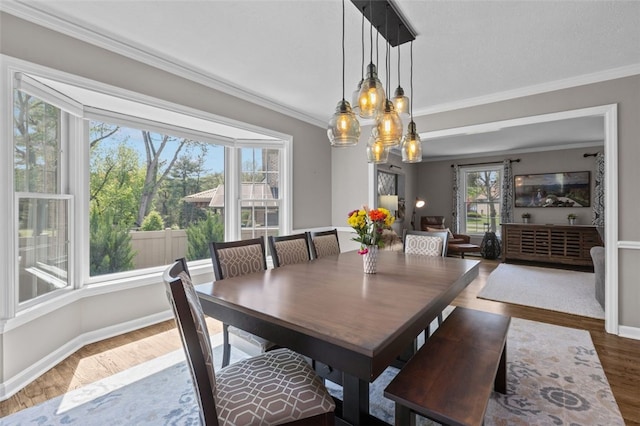809 Timber Trl, Collier Twp, PA 15071 - dining space featuring crown molding, wood finished floors, a chandelier, and baseboards