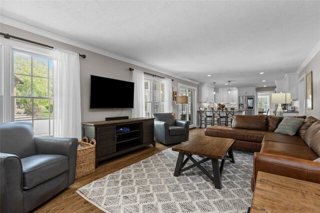 809 Timber Trl, Collier Twp, PA 15071 - living area with ornamental molding, healthy amount of natural light, a textured ceiling, and wood finished floors