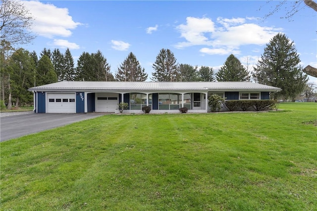 507 Moss Ln, Pymatuning Twp, PA 16125 - ranch-style home with a garage, a front yard, driveway, and metal roof
