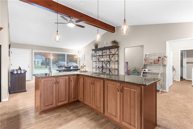 507 Moss Ln, Pymatuning Twp, PA 16125 - kitchen with a ceiling fan, dark stone counters, light carpet, and pendant lighting