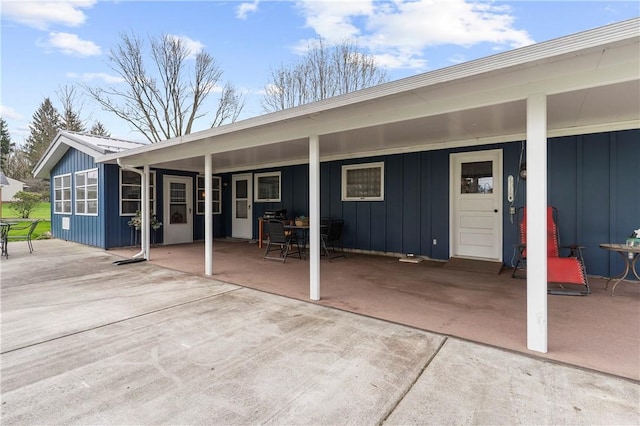 507 Moss Ln, Pymatuning Twp, PA 16125 - back of property with board and batten siding, a patio area, and outdoor dining space