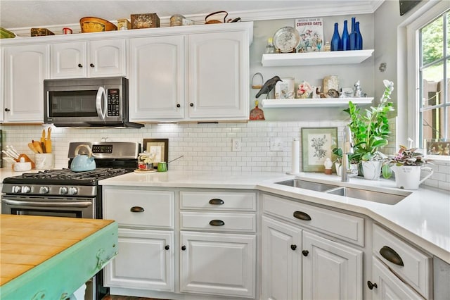 675 Village Green Blvd E, Adams Twp, PA 16046 - kitchen featuring appliances with stainless steel finishes, a sink, white cabinets, decorative backsplash, and light countertops