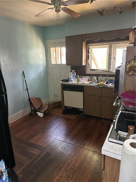 423 35th St, Mckeesport, PA 15132 - kitchen featuring white dishwasher, dark wood finished floors, light countertops, ceiling fan, and a sink