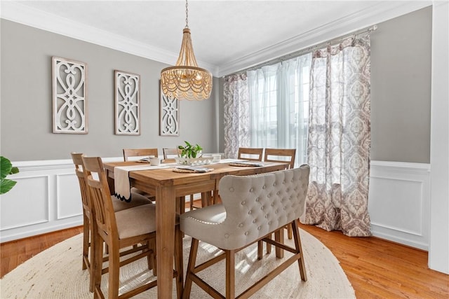 108 General Ct, Jackson Twp But, PA 16063 - dining area featuring ornamental molding, light wood-style flooring, a decorative wall, wainscoting, and a chandelier