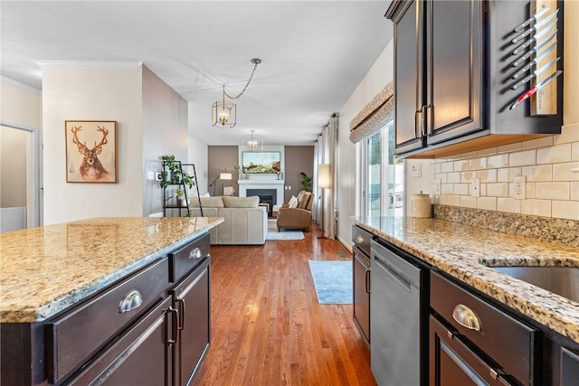 108 General Ct, Jackson Twp But, PA 16063 - kitchen with stainless steel dishwasher, wood finished floors, backsplash, light stone countertops, and dark brown cabinetry