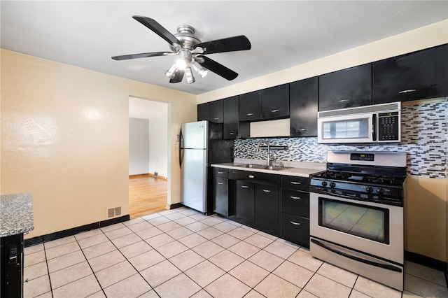1624 Rockford Ave, Brookline, PA 15226 - kitchen with appliances with stainless steel finishes, dark cabinets, a sink, and light countertops