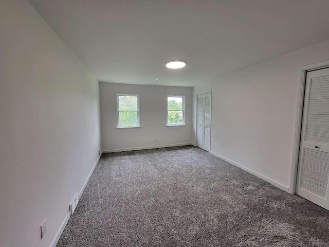 74 S Morgantown St, Fairchance, PA 15436 - unfurnished bedroom with two closets, carpet floors, and baseboards