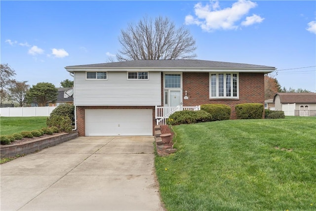 124 Wyndfield Dr, East Huntingdon, PA 15666 - raised ranch with brick siding, a garage, and concrete driveway