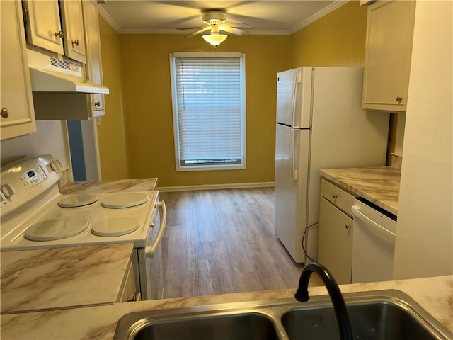 673 Robinwood Dr, Scott Twp Sal, PA 15216 - kitchen featuring white appliances, under cabinet range hood, ornamental molding, a sink, and light countertops