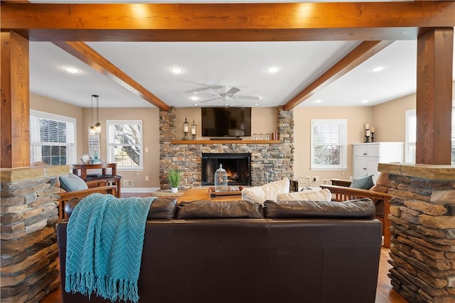 1299 Oakridge Rd, South Fayette, PA 15057 - living room featuring beamed ceiling, a stone fireplace, a ceiling fan, wood finished floors, and plenty of natural light