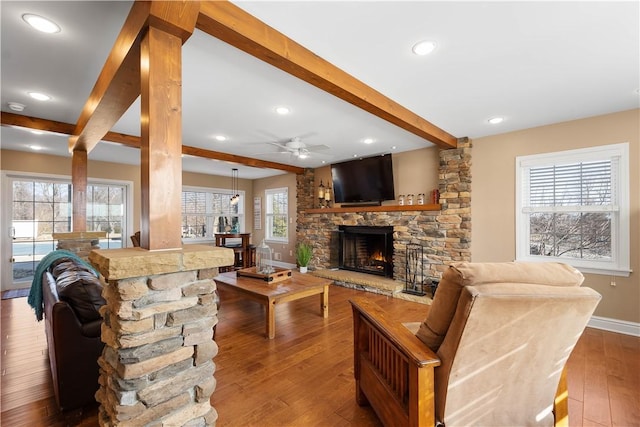 1299 Oakridge Rd, South Fayette, PA 15057 - living area with beamed ceiling, a stone fireplace, ceiling fan, baseboards, and hardwood / wood-style flooring