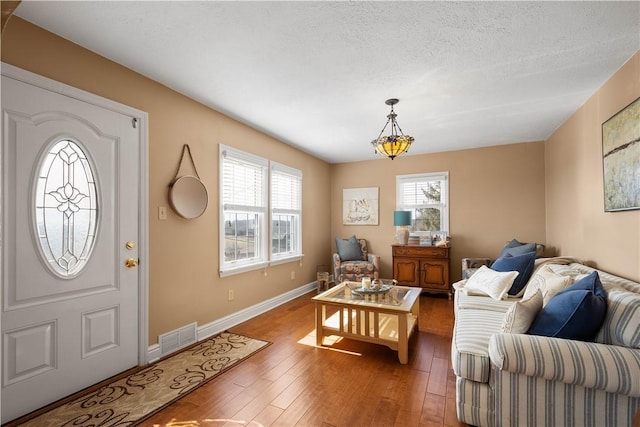 1299 Oakridge Rd, South Fayette, PA 15057 - living area featuring hardwood / wood-style flooring, baseboards, and a textured ceiling