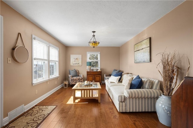 1299 Oakridge Rd, South Fayette, PA 15057 - living room featuring wood-type flooring, baseboards, and a textured ceiling