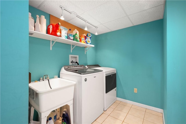 1299 Oakridge Rd, South Fayette, PA 15057 - washroom with separate washer and dryer, track lighting, light tile patterned floors, and baseboards