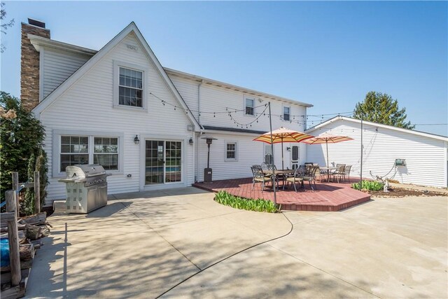 1299 Oakridge Rd, South Fayette, PA 15057 - rear view of house featuring outdoor dining space, a deck, a chimney, and a patio