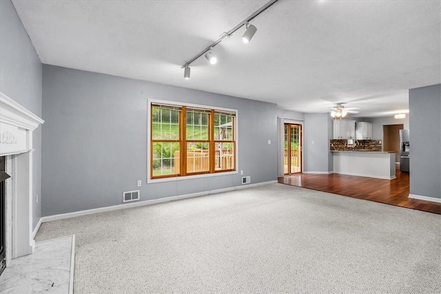 260 Fox Meadow Dr, Pine Twp Nal, PA 15090 - unfurnished living room featuring carpet, healthy amount of natural light, rail lighting, and ceiling fan