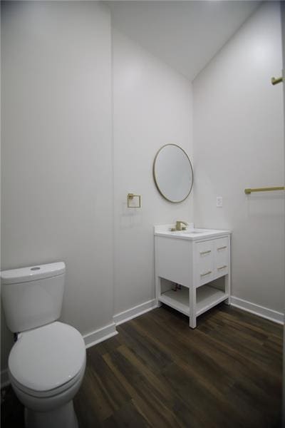 2040 Constitution Blvd, Elizabeth Twp/Boro, PA 15135 - half bathroom with wood finished floors, vanity, baseboards, toilet, and vaulted ceiling