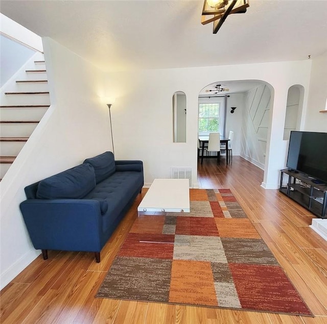 851 Kennebec St, Greenfield, PA 15217 - living area with arched walkways, wood finished floors, stairs, and ceiling fan