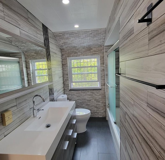 851 Kennebec St, Greenfield, PA 15217 - bathroom with tile walls, toilet, plenty of natural light, vanity, and  shower combination