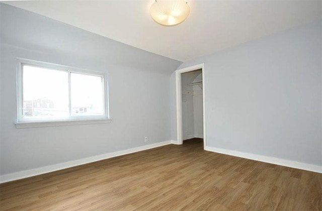 851 Kennebec St, Greenfield, PA 15217 - unfurnished bedroom featuring vaulted ceiling, light wood-type flooring, baseboards, and a closet