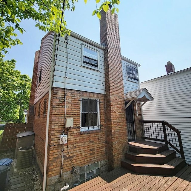 851 Kennebec St, Greenfield, PA 15217 - back of property featuring brick siding, a chimney, a deck, and central air condition unit