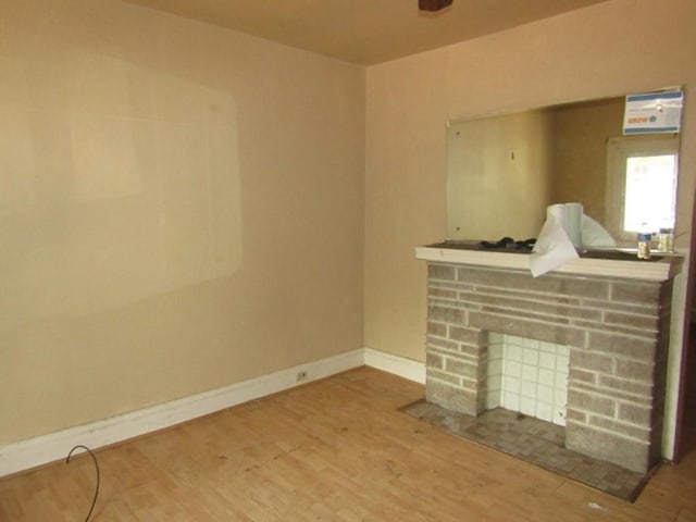 1220 Thelma St, Marshall Shadeland, PA 15212 - unfurnished living room featuring wood finished floors, a stone fireplace, and baseboards