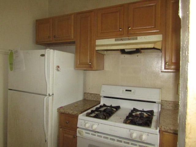 1220 Thelma St, Marshall Shadeland, PA 15212 - kitchen featuring white appliances, under cabinet range hood, and brown cabinets