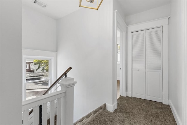 8952 Eastwood Rd, Penn Hills, PA 15235 - corridor with an upstairs landing, dark carpet, and baseboards