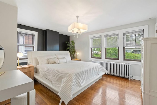 503 6th St, Oakmont, PA 15139 - bedroom featuring radiator, multiple windows, a chandelier, and wood finished floors