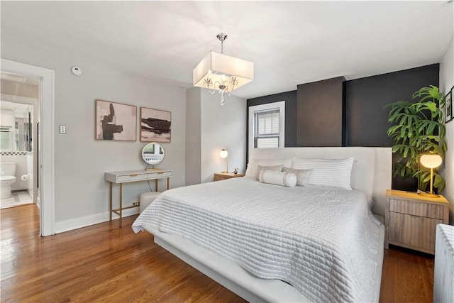 503 6th St, Oakmont, PA 15139 - bedroom with a chandelier, baseboards, wood finished floors, and radiator