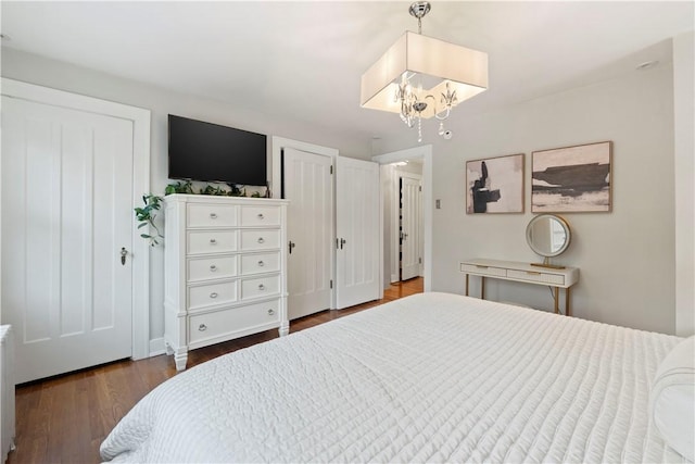 503 6th St, Oakmont, PA 15139 - bedroom with dark wood-type flooring and a chandelier