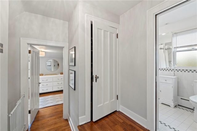 503 6th St, Oakmont, PA 15139 - corridor with wood finished floors and a baseboard radiator