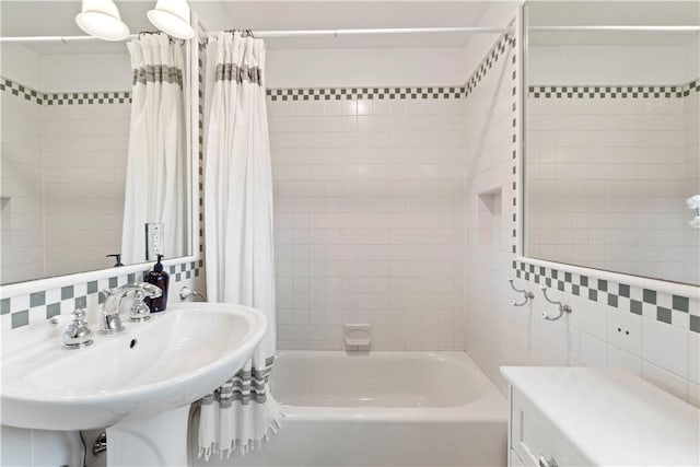 503 6th St, Oakmont, PA 15139 - bathroom featuring shower / tub combo with curtain, tile walls, a sink, and tasteful backsplash