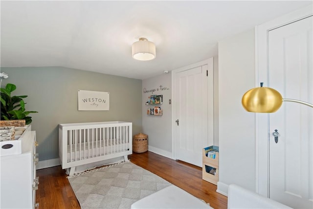 503 6th St, Oakmont, PA 15139 - bedroom with wood finished floors, baseboards, and a crib