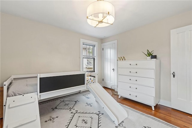 503 6th St, Oakmont, PA 15139 - bedroom featuring a chandelier, wood finished floors, and baseboards