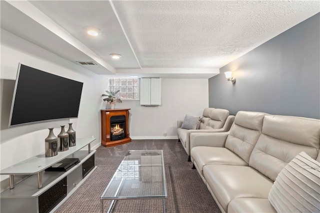 503 6th St, Oakmont, PA 15139 - living area featuring dark colored carpet, a textured ceiling, a warm lit fireplace, and baseboards