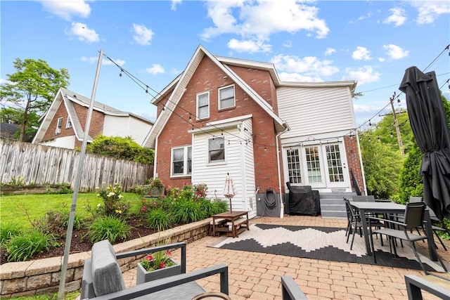 503 6th St, Oakmont, PA 15139 - rear view of property with brick siding, a patio area, entry steps, and outdoor dining space