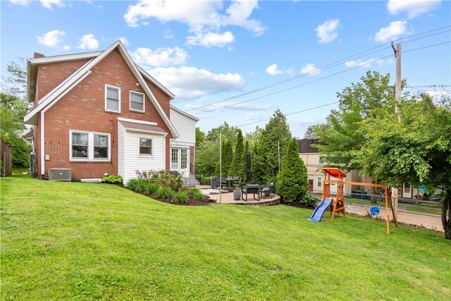 503 6th St, Oakmont, PA 15139 - back of property featuring brick siding, a patio, a playground, and central AC unit