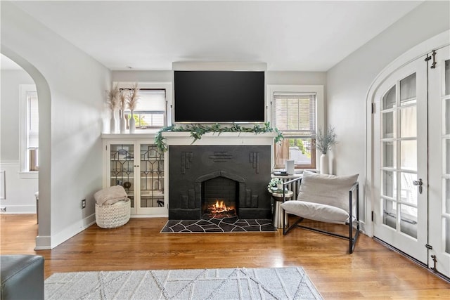 503 6th St, Oakmont, PA 15139 - living room with wood finished floors, arched walkways, and a fireplace