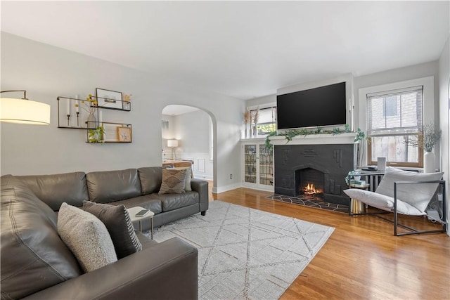 503 6th St, Oakmont, PA 15139 - living area featuring arched walkways, wood finished floors, and a fireplace with flush hearth