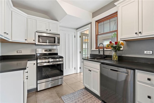 503 6th St, Oakmont, PA 15139 - kitchen featuring appliances with stainless steel finishes, a sink, dark countertops, and white cabinets