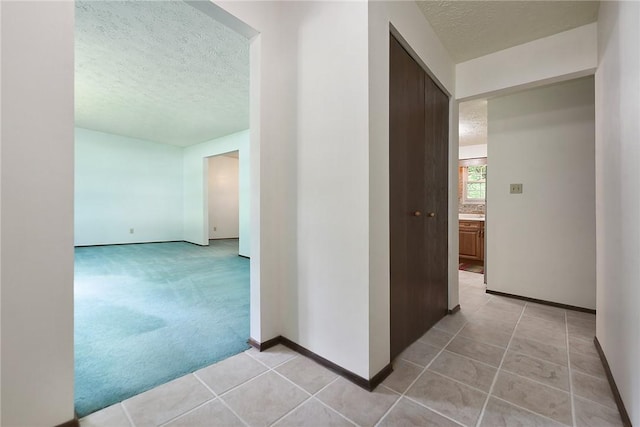 662 Huntington Dr, Cranberry Twp, PA 16066 - corridor featuring a textured ceiling, light tile patterned floors, and light colored carpet
