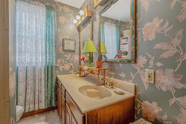 306 Meadow Ave, Charleroi Boro, PA 15022 - full bath with wallpapered walls, double vanity, and toilet