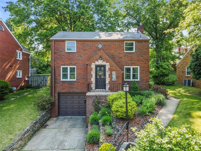 752 Washington, Ross Twp, PA 15229 - view of front of house featuring driveway, a chimney, a garage, brick siding, and a front yard