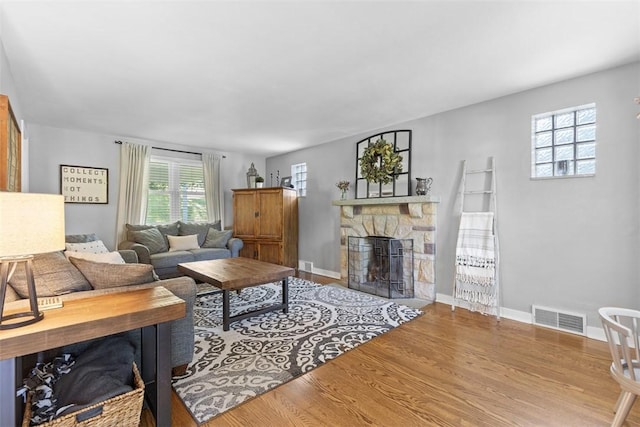 752 Washington, Ross Twp, PA 15229 - living area featuring a stone fireplace, wood finished floors, and baseboards