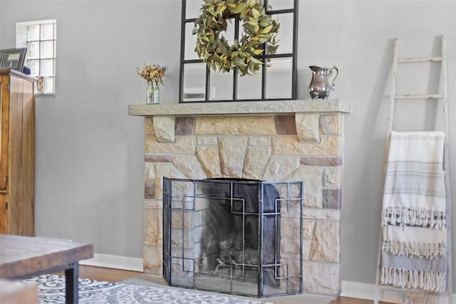 752 Washington, Ross Twp, PA 15229 - detailed view of baseboards, a stone fireplace, and wood finished floors