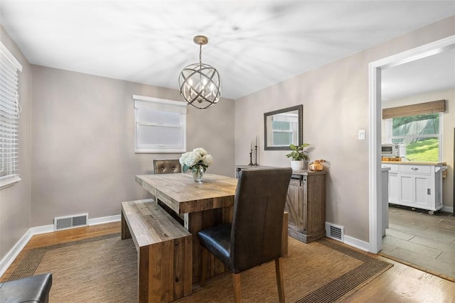 752 Washington, Ross Twp, PA 15229 - dining space with a chandelier, baseboards, and wood finished floors